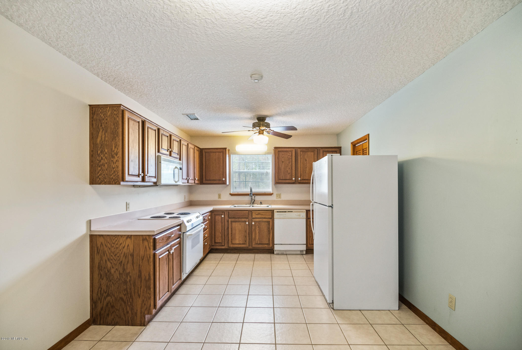 1435 Scott Road St. Johns, FL 32259 - Photo 46 of 65 a kitchen with a refrigerator a sink and dishwasher
