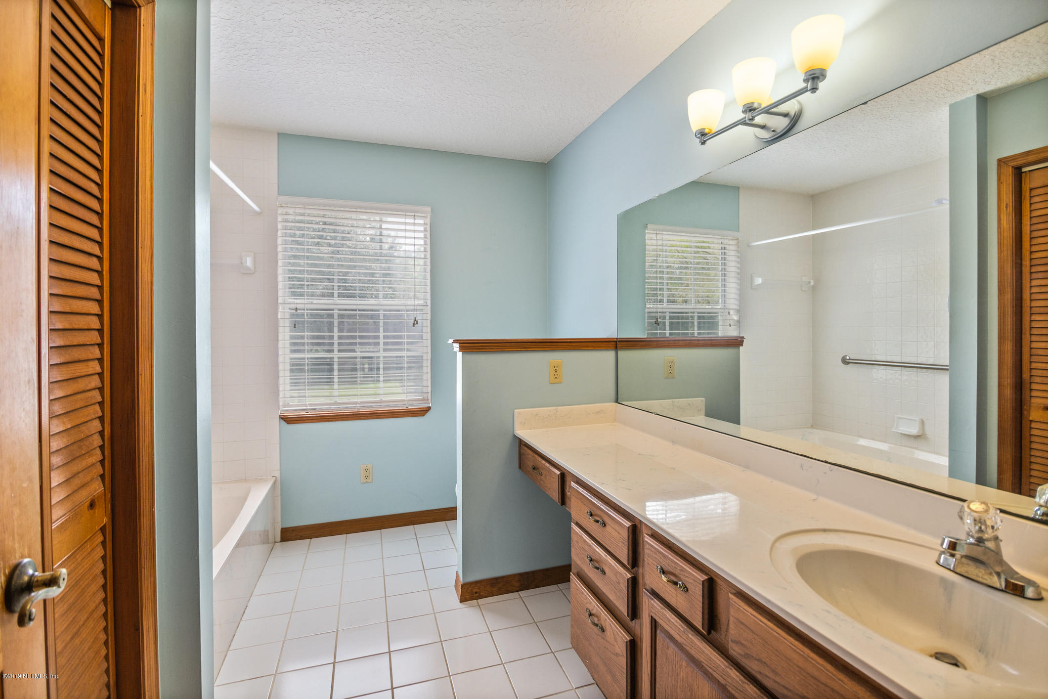 1435 Scott Road St. Johns, FL 32259 - Photo 50 of 65 a bathroom with a sink a vanity and a mirror