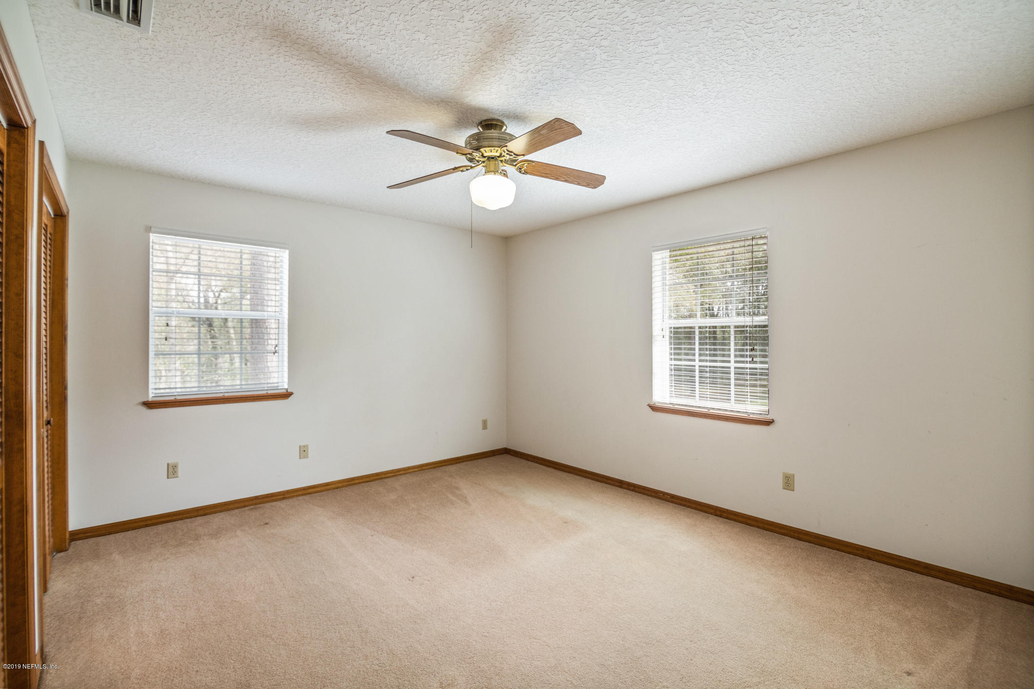 1435 Scott Road St. Johns, FL 32259 - Photo 51 of 65 an empty room with windows and fan
