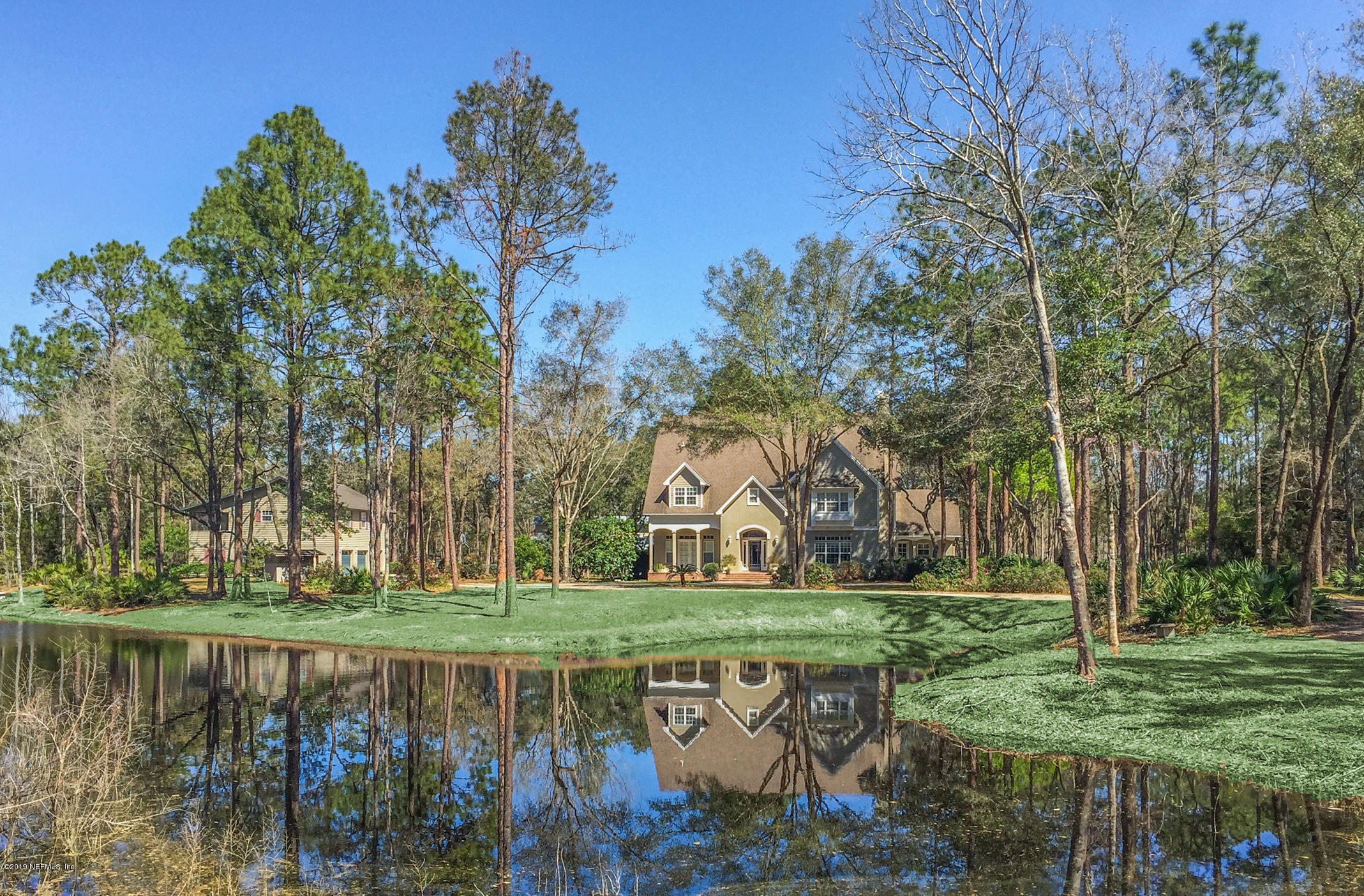 1435 Scott Road St. Johns, FL 32259 - Photo 55 of 65 a view of a lake with a bench under an umbrella