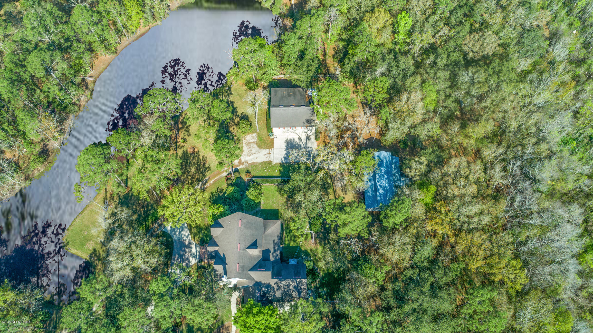 1435 Scott Road St. Johns, FL 32259 - Photo 60 of 65 an aerial view of a house with a yard and trees all around