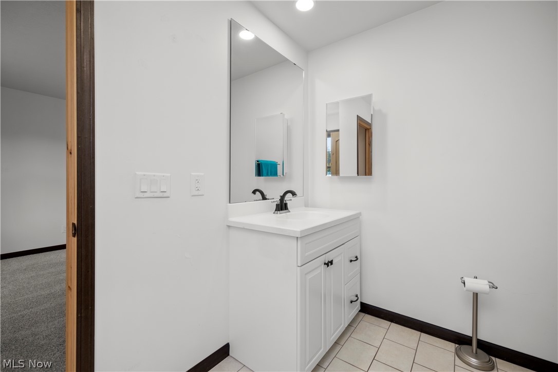 6760 Mason Road Berlin Heights, OH 44814 - Photo 19 of 49 Bathroom with vanity, light tile patterned floors, and recessed lighting