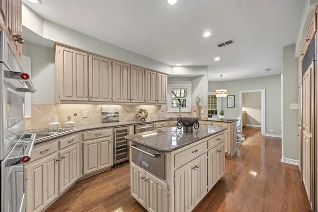 a kitchen with granite countertop a sink stove and cabinets