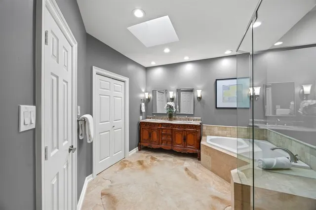 a large spacious bathroom with a large tub and shower