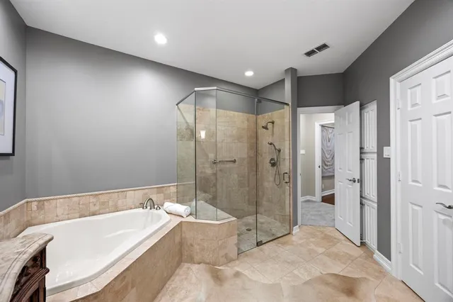 a bathroom with a bathtub a toilet and a shower