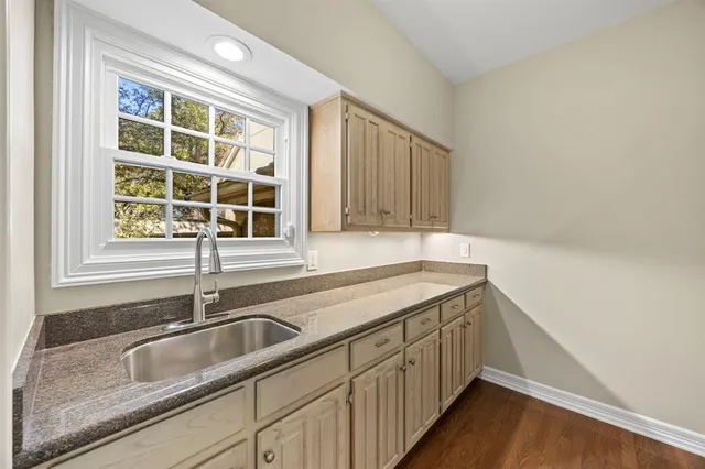 a kitchen with a sink and a window