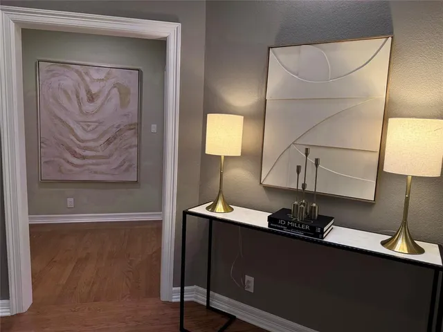 a room with a mirror and a lamp on table