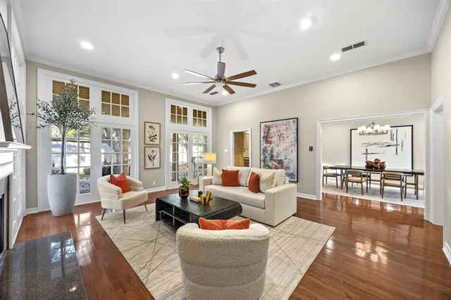 a living room with furniture a table and a large window