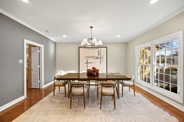 a dining room with furniture window and wooden floor