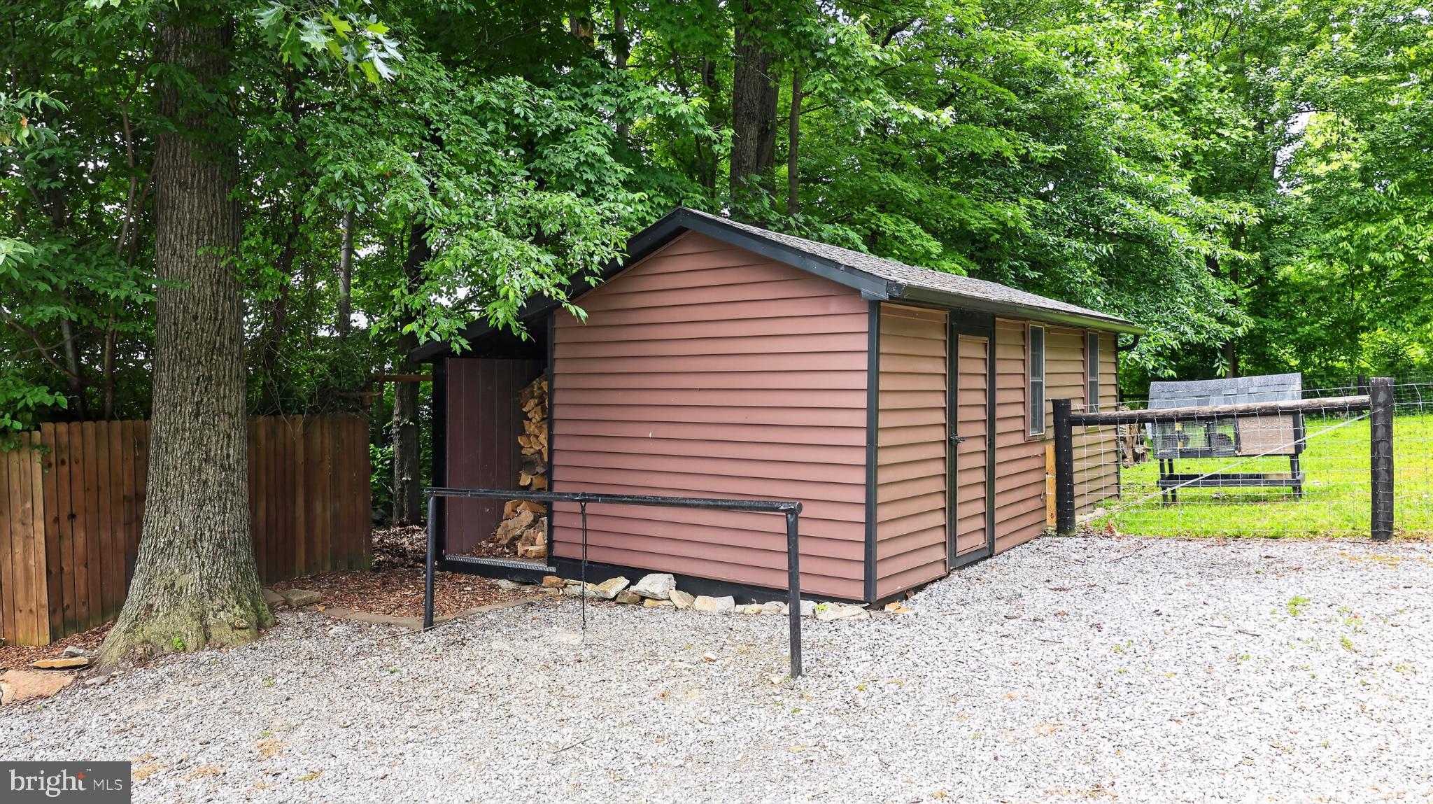 5325 Hammond Road New Holland, PA 17557 - Photo 61 of 73 Charming shed nestled in lush greenery.