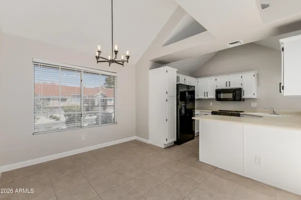 a view of a kitchen with microwave and a ceiling fan