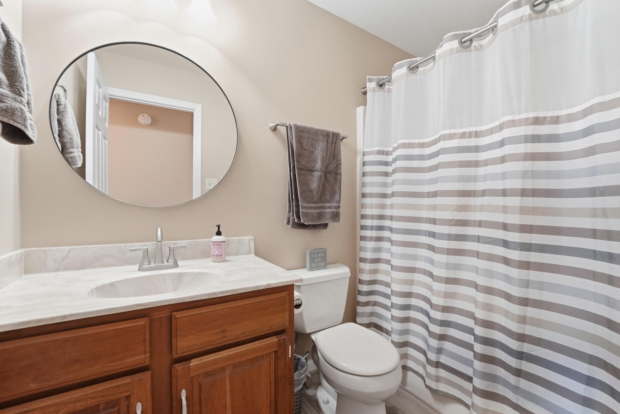 11337 Old Stillhouse Road Boston, VA 22713 - Photo 41 of 58 a bathroom with a granite countertop toilet sink and mirror