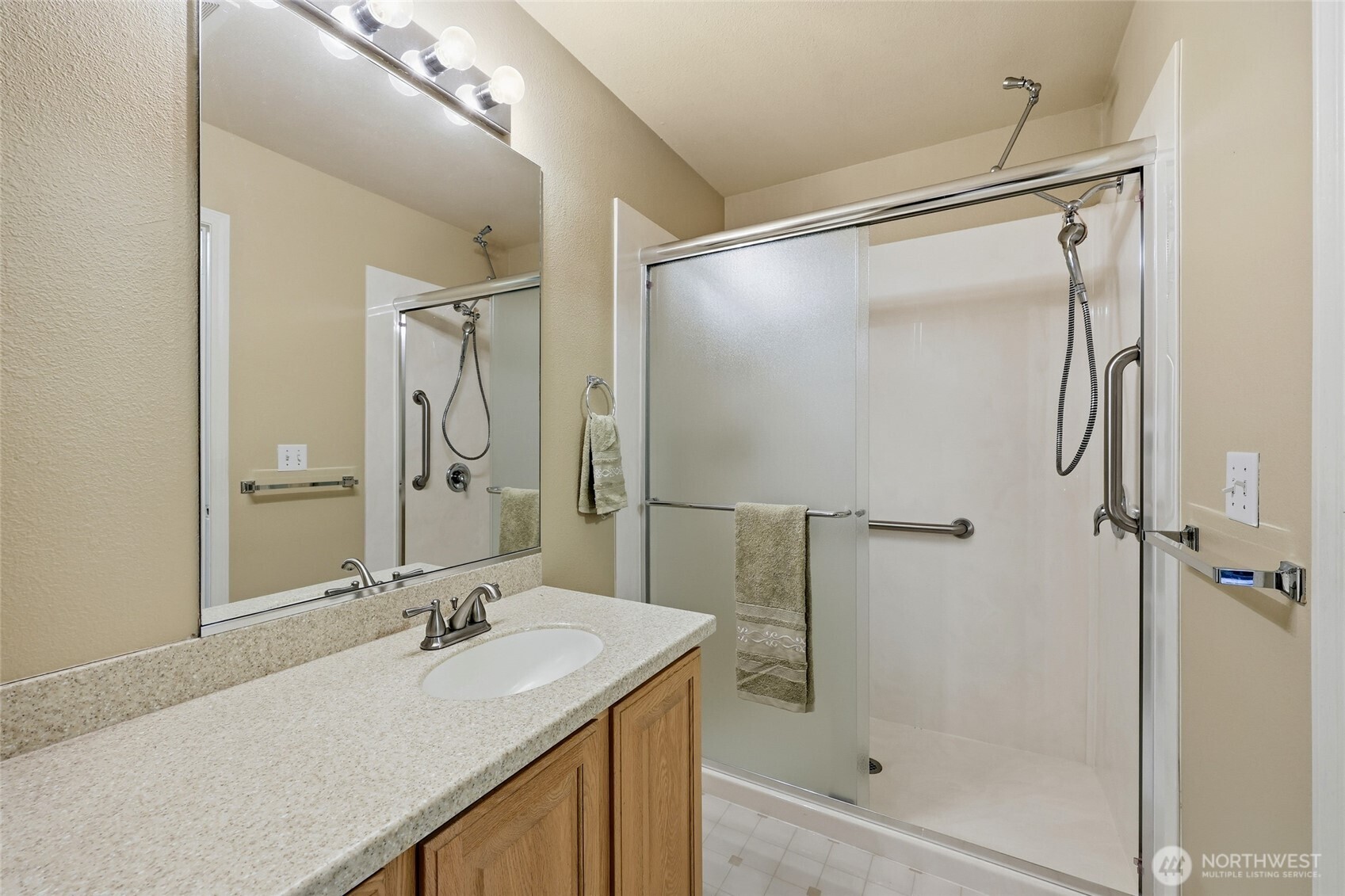 1083 5th Street Steilacoom, WA 98388 - Photo 12 of 39 a bathroom with a shower sink vanity and mirror