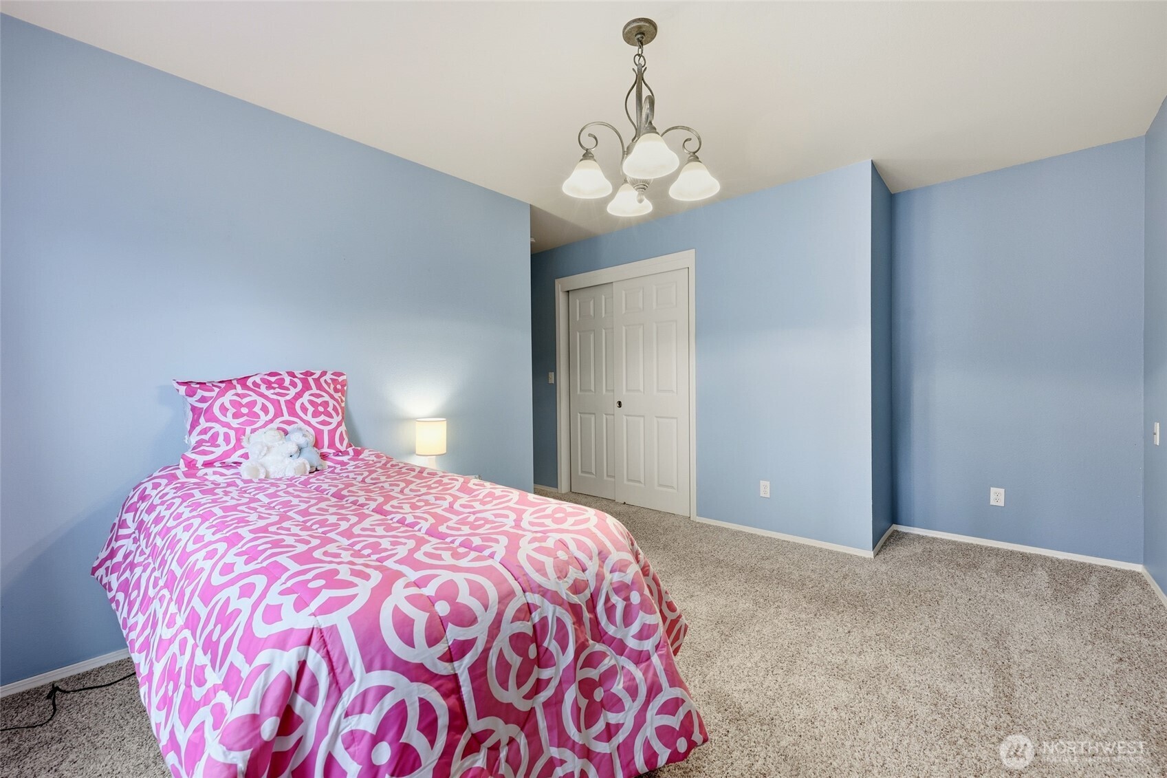 1083 5th Street Steilacoom, WA 98388 - Photo 15 of 39 a bedroom with a large bed and a chandelier