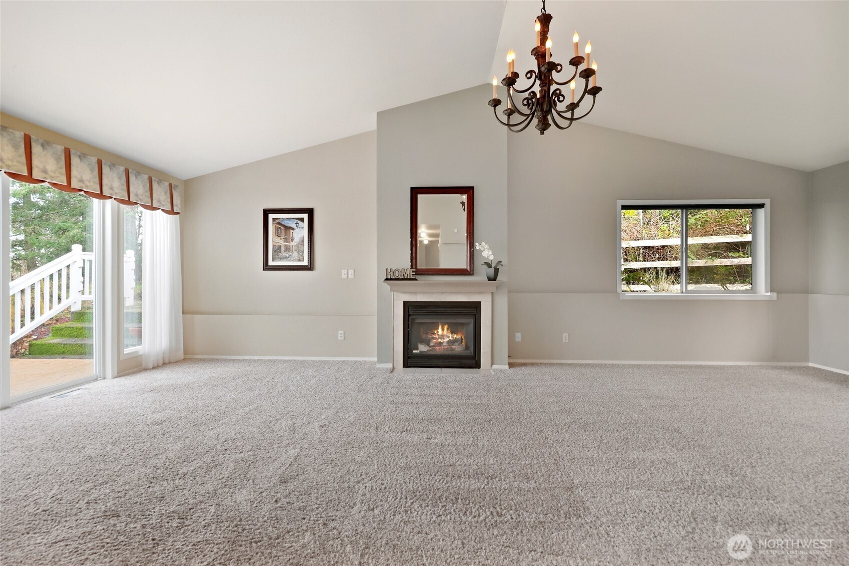 1083 5th Street Steilacoom, WA 98388 - Photo 2 of 39 a view of an empty room with a fireplace and a window