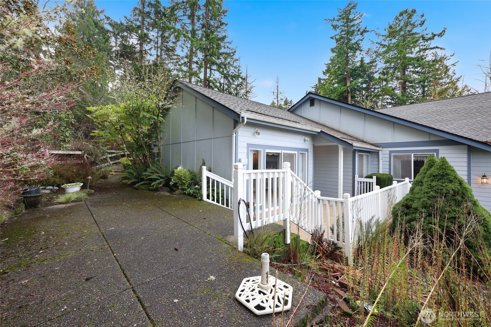 1083 5th Street Steilacoom, WA 98388 - Photo 24 of 39 a view of a house with a small yard and a garden