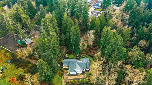 an aerial view of a house with a yard