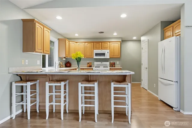 a kitchen with a sink refrigerator and cabinets