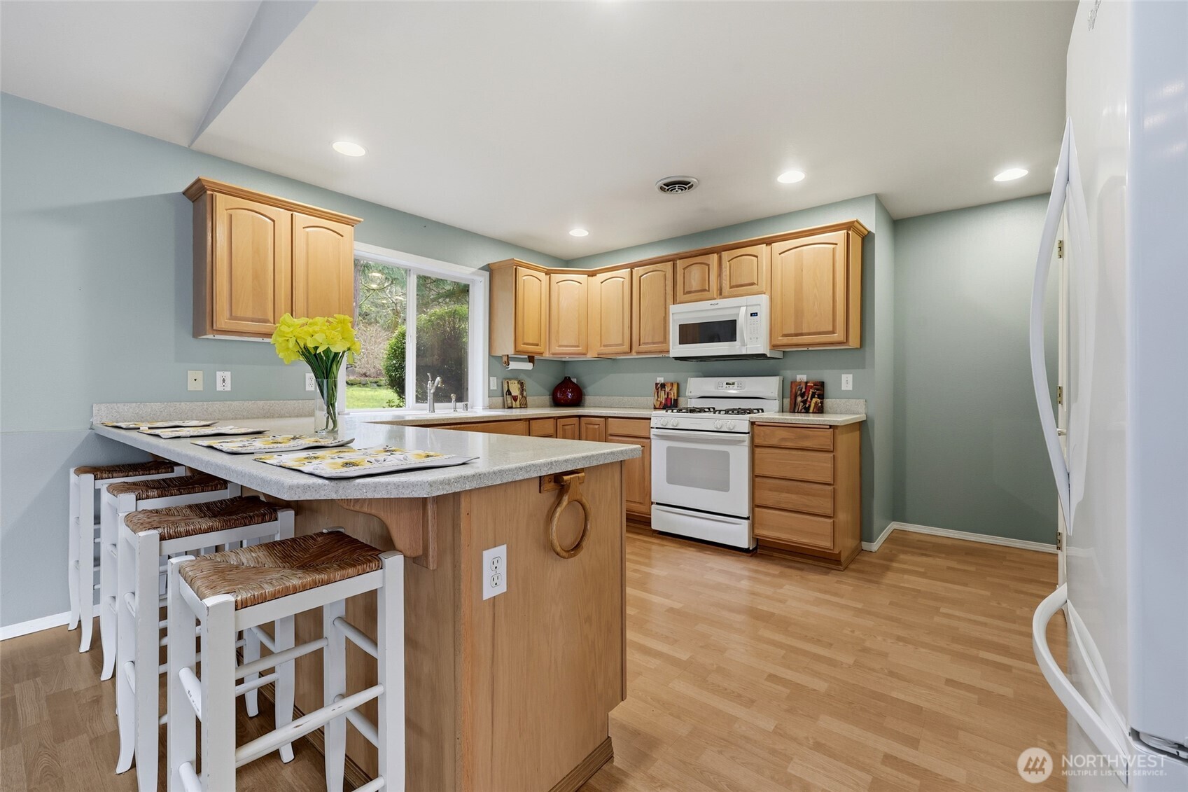1083 5th Street Steilacoom, WA 98388 - Photo 5 of 39 a kitchen with stainless steel appliances granite countertop a stove a sink dishwasher and a refrigerator with wooden floor