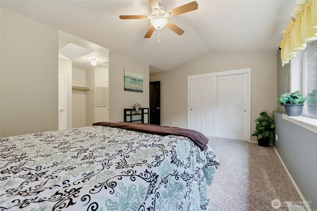 a bedroom with a bed and a potted plant