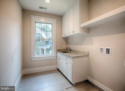 827 Ninovan Road Southeast Vienna, VA 22180 - Photo 21 of 30 Upper level laundry room w/ a sink & granite
