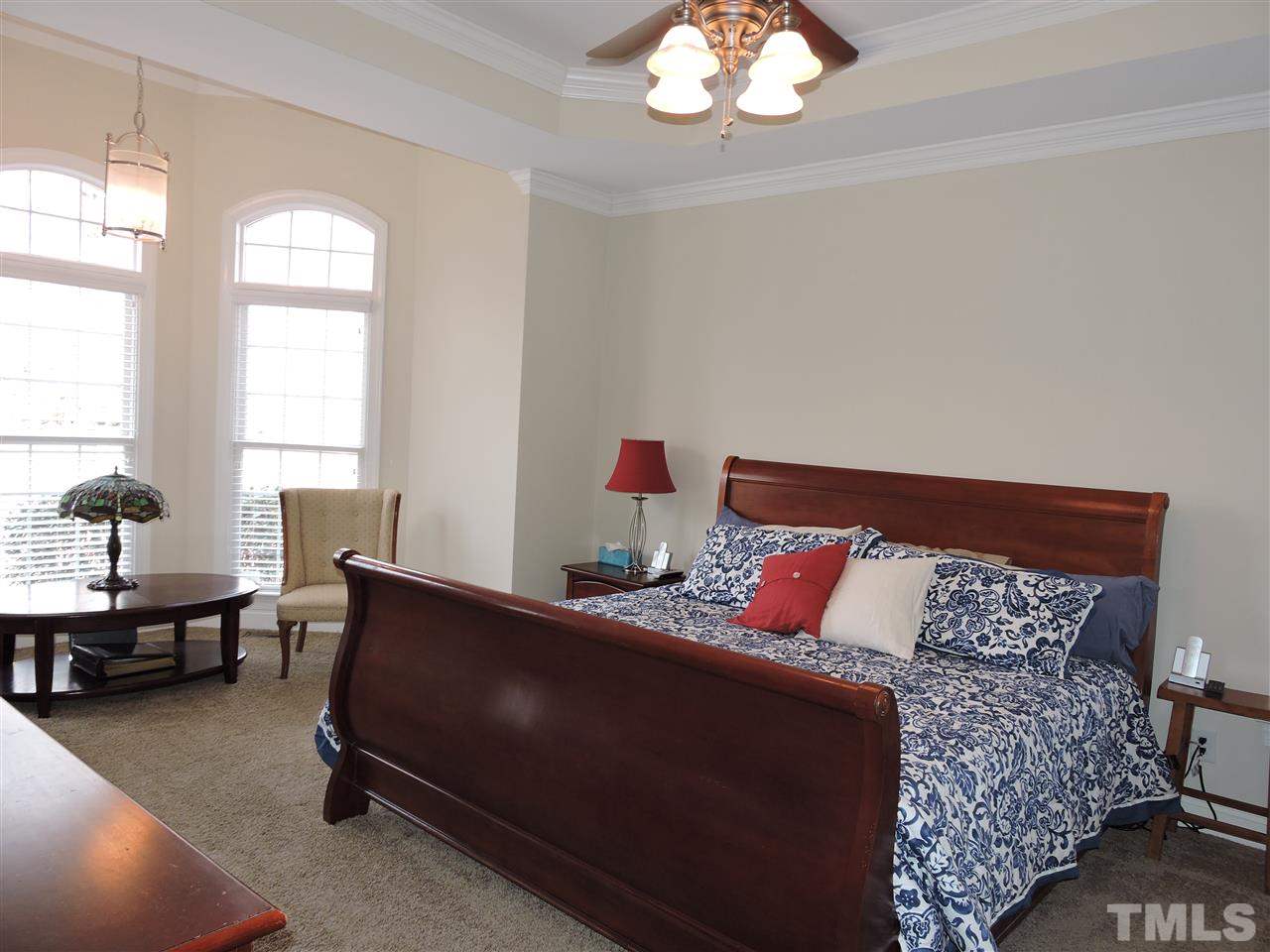 187 North Old Lantern Road Timberlake, NC 27583 - Photo 12 of 25 a bedroom with a bed and a chandelier
