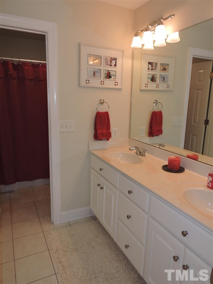 187 North Old Lantern Road Timberlake, NC 27583 - Photo 16 of 25 a bathroom with a double vanity sink and a mirror