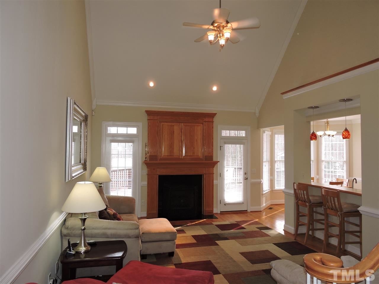 187 North Old Lantern Road Timberlake, NC 27583 - Photo 3 of 25 a living room with furniture a fireplace and a chandelier