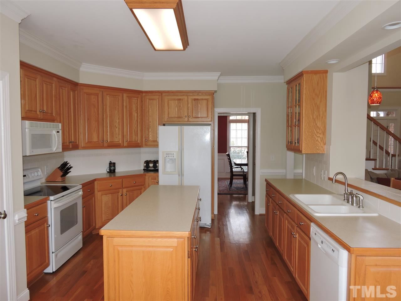 187 North Old Lantern Road Timberlake, NC 27583 - Photo 5 of 25 a kitchen with stainless steel appliances granite countertop a sink stove and refrigerator