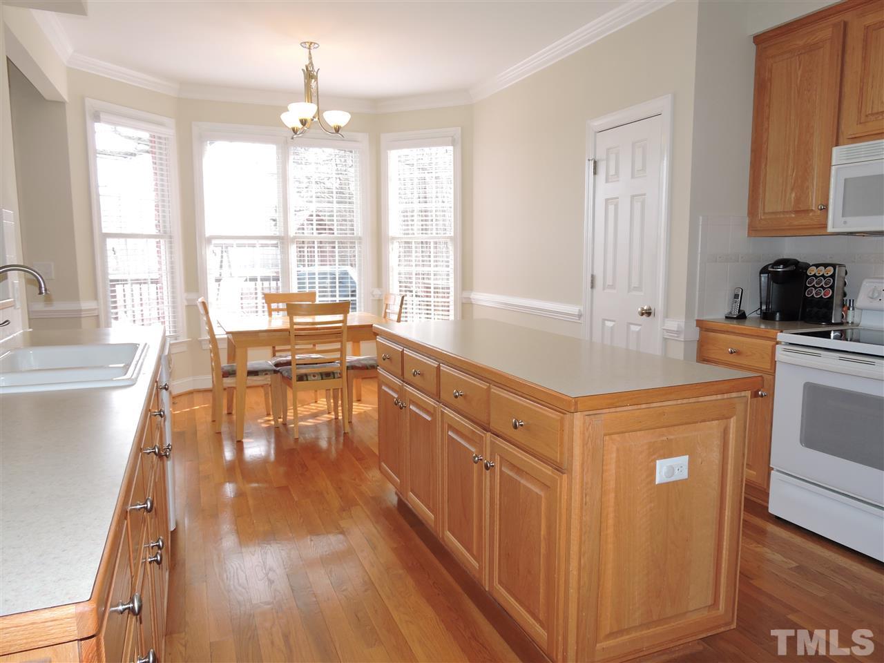 187 North Old Lantern Road Timberlake, NC 27583 - Photo 10 of 25 a large kitchen with kitchen island granite countertop a large window a sink and stainless steel appliances