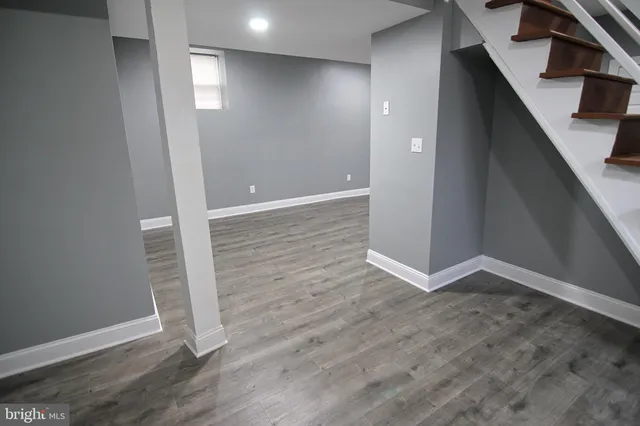 an empty room with wooden floor