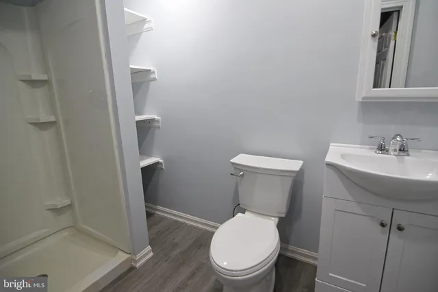 a white toilet sitting next to a bathroom sink