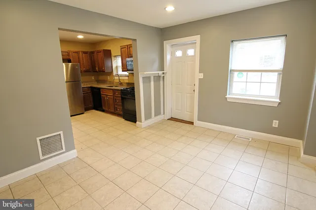 a view of kitchen with granite countertop cabinets and stainless steel appliances