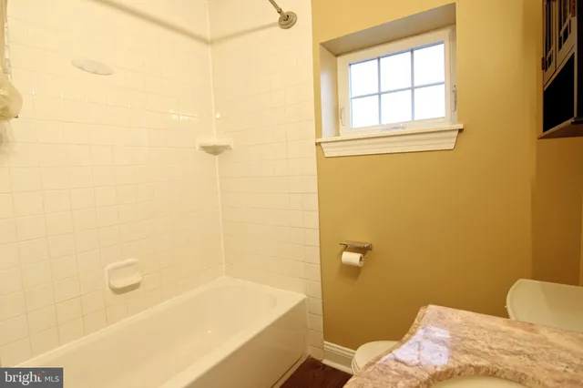 a bathroom with a bathtub and shower