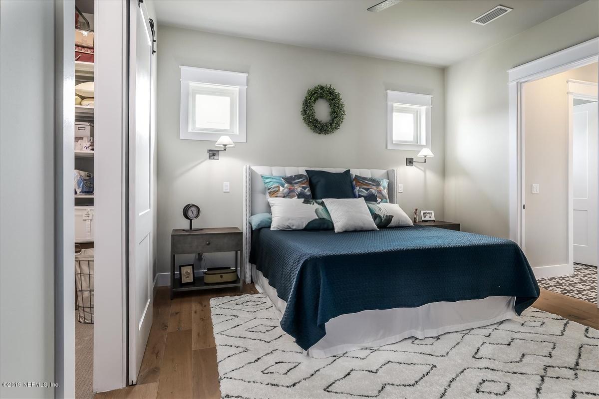 80 Ferrol Road St. Augustine, FL 32084 - Photo 15 of 32 a bedroom with a bed and a mirror on dresser