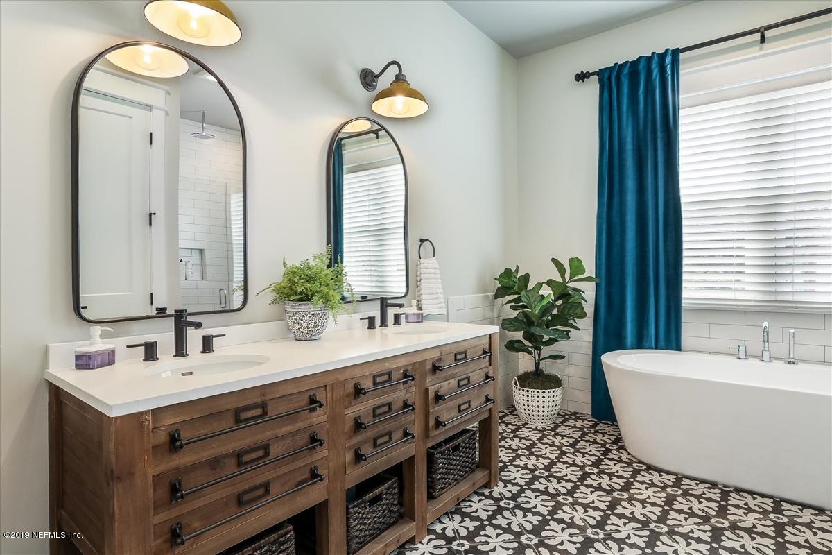 80 Ferrol Road St. Augustine, FL 32084 - Photo 17 of 32 a bathroom with a double vanity sink and a mirror
