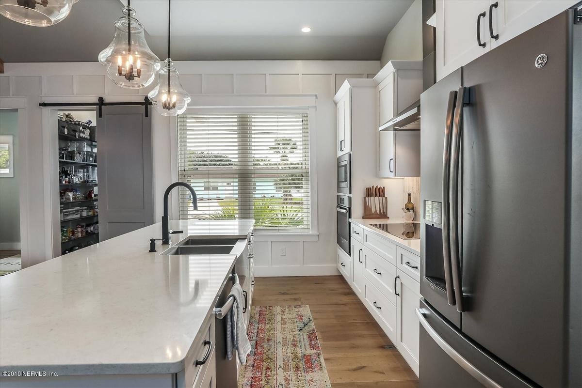 80 Ferrol Road St. Augustine, FL 32084 - Photo 10 of 32 a kitchen with stainless steel appliances granite countertop a sink refrigerator and cabinets