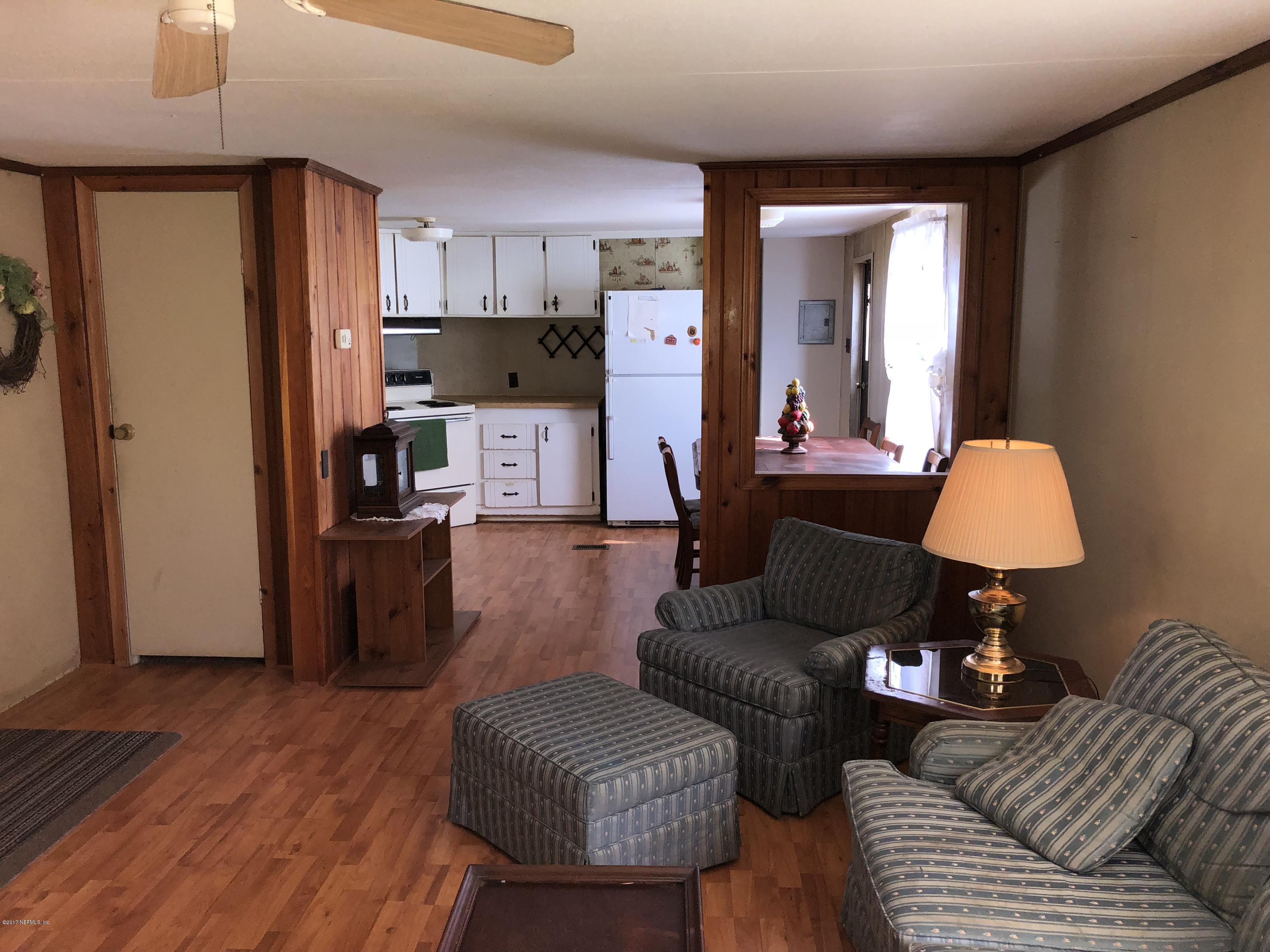 128 Riverside Avenue Satsuma, FL 32189 - Photo 4 of 18 Living room looking in kitchen