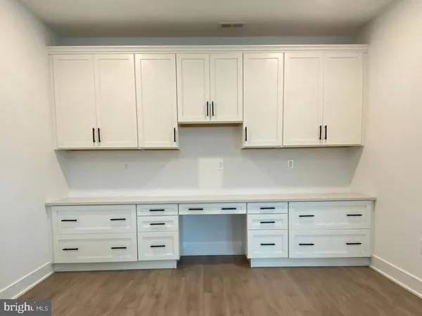 a view of cabinets and wooden floor