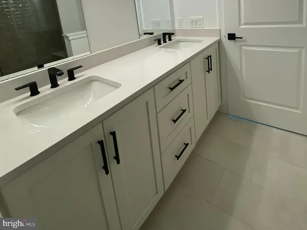 a bathroom with a double vanity sink and mirror