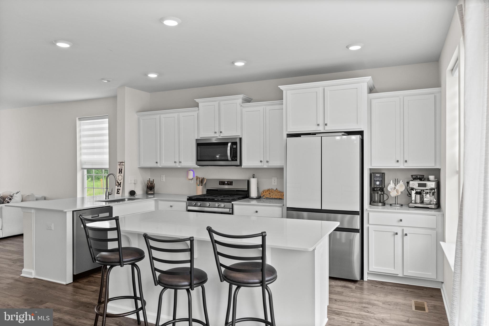 414 Monte Farm Road Mount Laurel, NJ 08054 - Photo 6 of 27 a kitchen with stainless steel appliances a stove a sink a refrigerator white cabinets and wooden floor