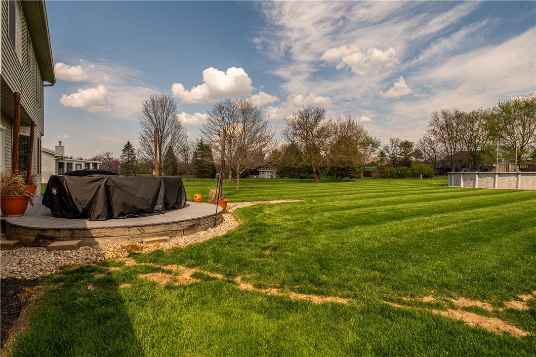 3628 Petre Road Springfield, OH 45502 - Photo 38 of 52 This expansive yard features a spacious deck and a pristine lawn, perfect for outdoor living and recreation.