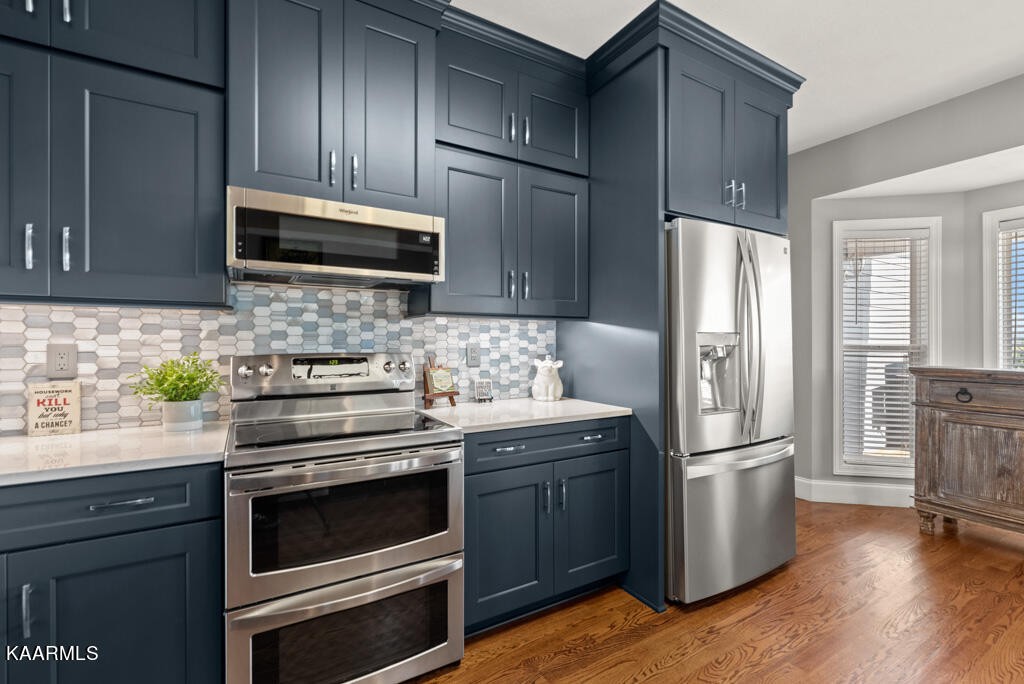 2582 Meadow Road West Greenback, TN 37742 - Photo 13 of 60 a kitchen with a refrigerator stove and wooden cabinets