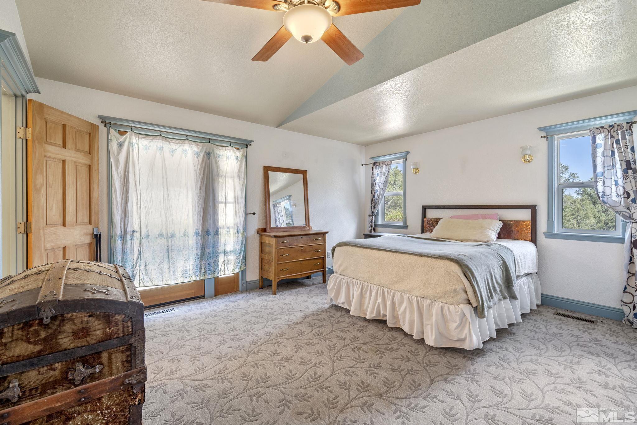 21410 Sazarac Road Reno, NV 89521 - Photo 18 of 38 a bedroom with a bed couch and window