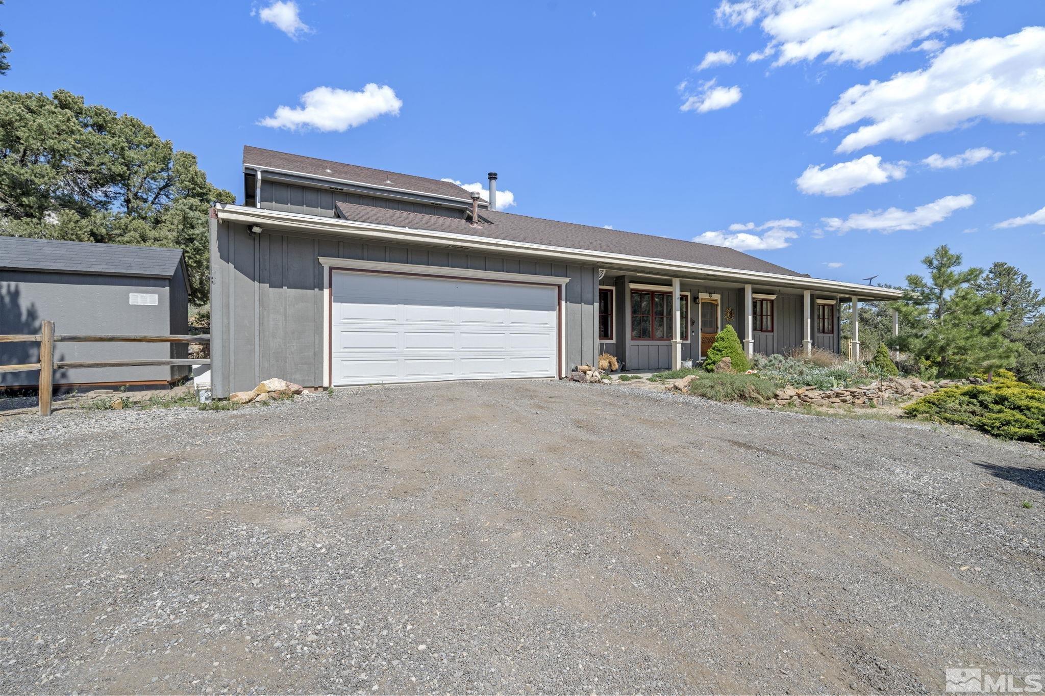 21410 Sazarac Road Reno, NV 89521 - Photo 3 of 38 a view of house with garage and plants