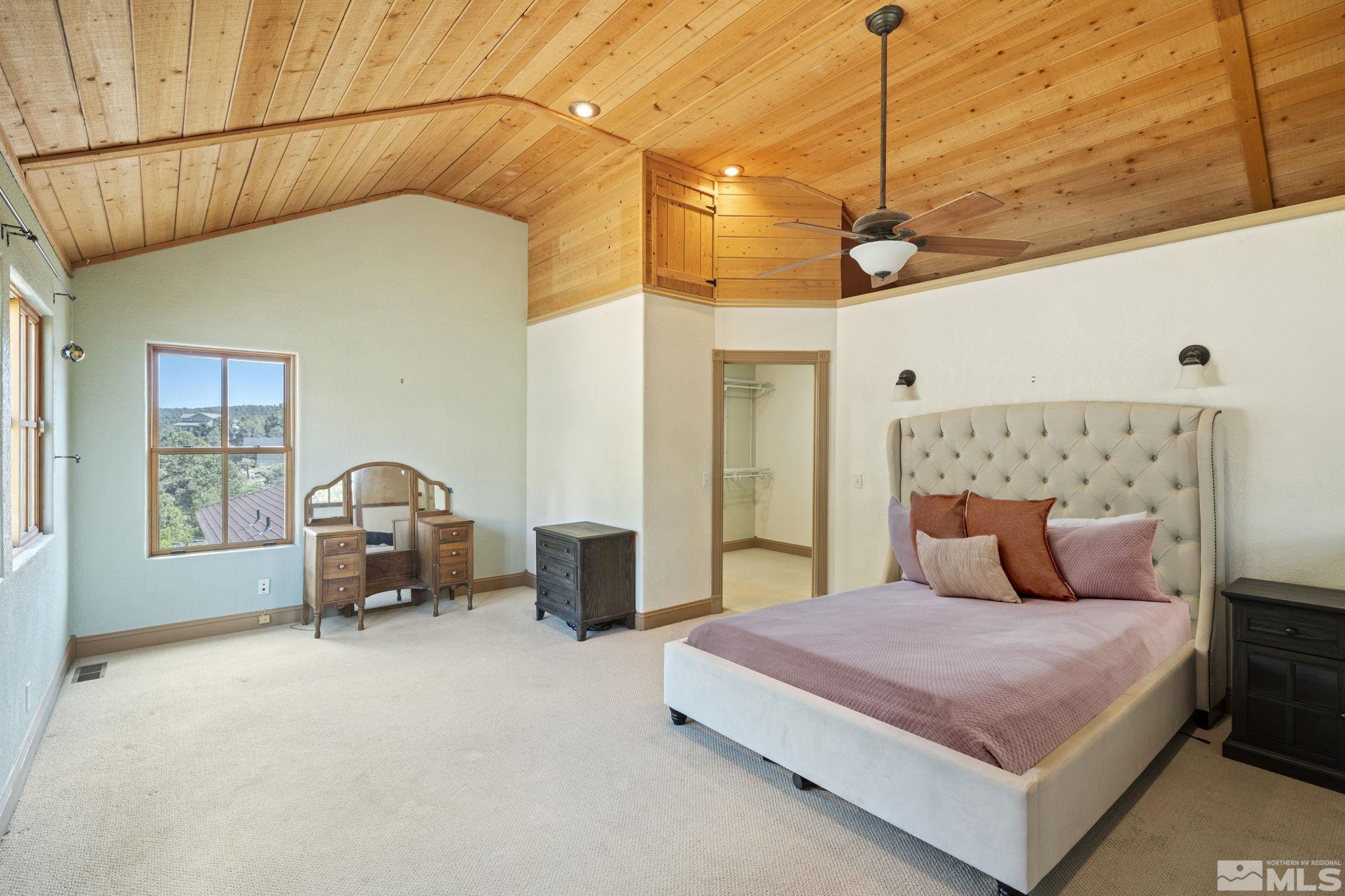 21410 Sazarac Road Reno, NV 89521 - Photo 38 of 38 a bedroom with a large bed and a chandelier