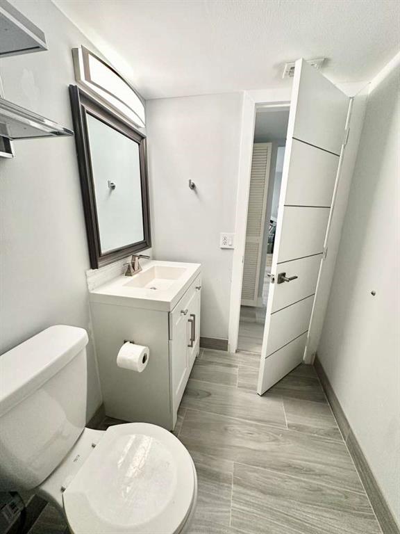 299 North Riverside Drive, Unit PH 5 Pompano Beach, FL 33062 - Photo 11 of 19 a white toilet sitting next to a bathroom sink