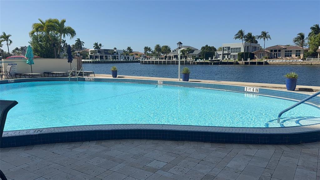299 North Riverside Drive, Unit PH 5 Pompano Beach, FL 33062 - Photo 16 of 19 a view of swimming pool with outdoor seating and lake view