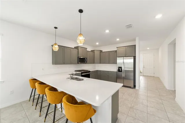 a kitchen with a table chairs sink and cabinets