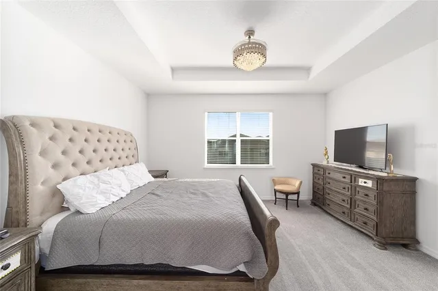 a bedroom with a bed and flat screen tv